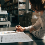 Technician servicing an industrial barcode printer under a service contract