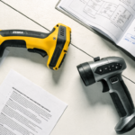 Industrial barcode scanner with spec sheet comparison on warehouse desk