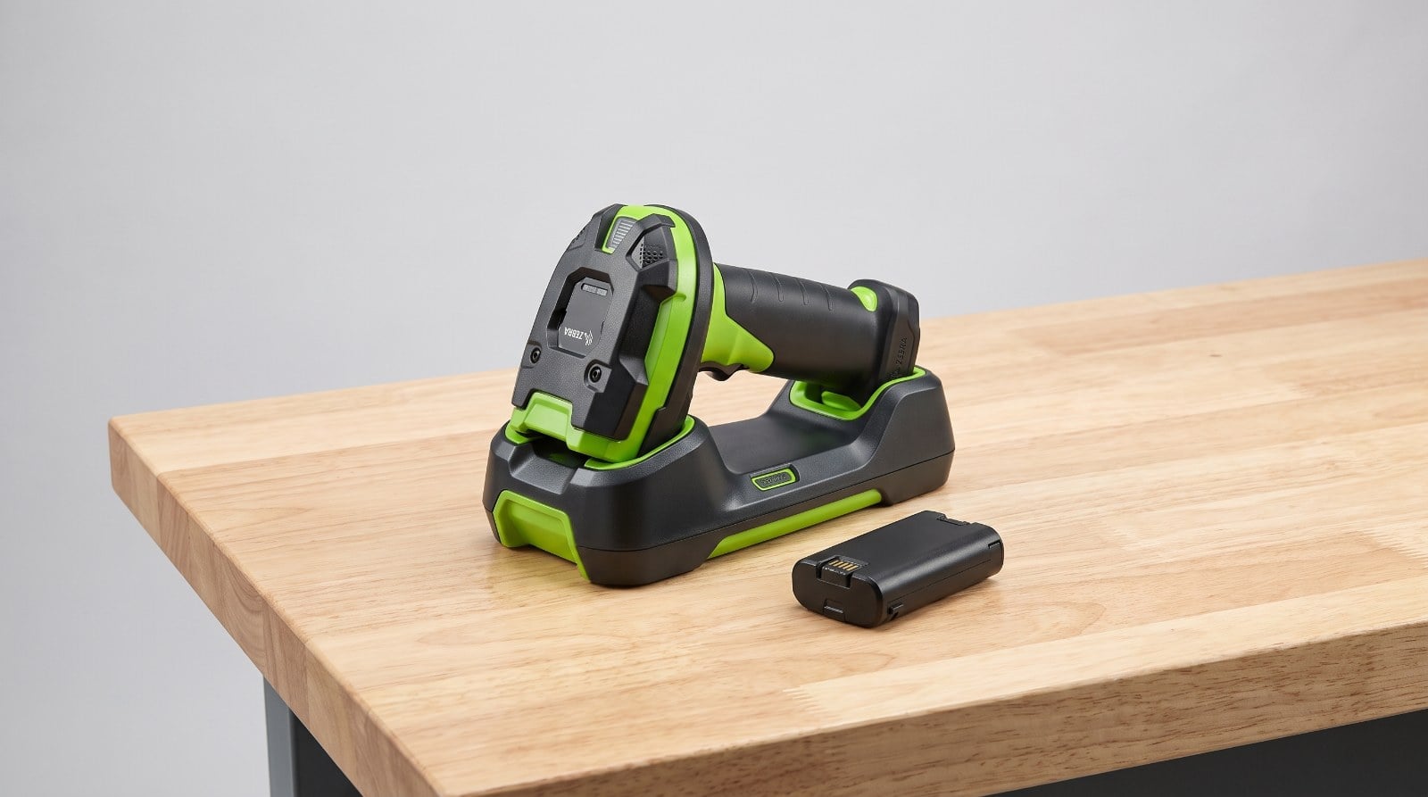 Zebra DS3678 cordless barcode scanner in charging cradle with spare battery pack