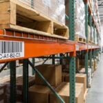 Warehouse pallet rack beam with a barcode location label applied to the beam face