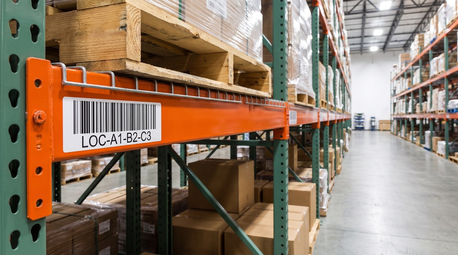 Warehouse pallet rack beam with a barcode location label applied to the beam face